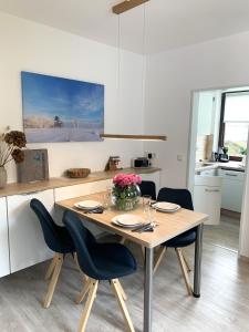Una cocina con una mesa y sillas de madera. en Winterberg Appartement 21114, en Winterberg