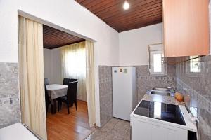 a kitchen with a refrigerator and a table at Country House Vukmanovic Bukovik in Virpazar +12 photos