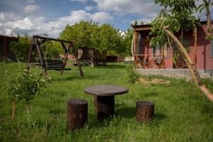 a stool sitting in the grass next to a playground at Noravank L-and-L in Namazalu