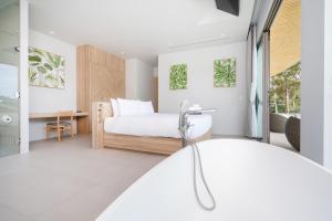 Postel nebo postele na pokoji v ubytování Himmapana Villas - Hills