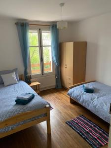 a bedroom with two beds and a window at Les Roseries Boutique Gite in Clussais-la-Pommeraie
