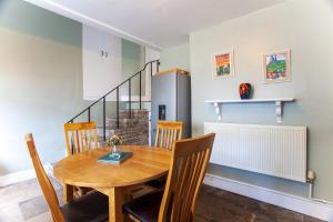 a dining room with a wooden table and chairs at Drury's in Corfe Castle