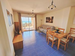 a living room with a couch and a table at Primera línea de playa Naturista in Vera