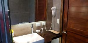 a bathroom with a white sink and a mirror at CASA AZUL LIMAY VILLA LA ANGOSTURA in Villa La Angostura +28 photos