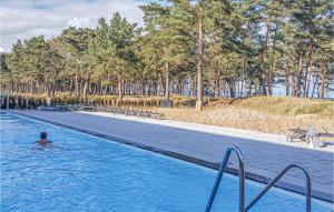 a person in the water in a swimming pool at Prora Solitaire Avida Loft 4 in Binz