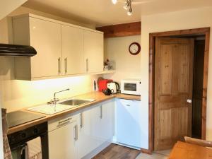 a kitchen with white cabinets and a sink at Valerian in York