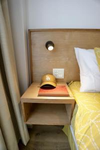 a hat sitting on a table next to a bed at Gente del Sur - Cinco Hermanos in Ushuaia