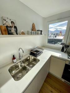 a kitchen with a sink and a window at Gente del Sur - Cinco Hermanos in Ushuaia