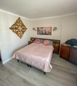 Apartament blisko morza Carmen في كولوبرزيغ: غرفة نوم بسرير كبير مع بطانية وردية