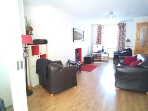 a living room with two chairs and a couch at Church Street Cottage in Rosscarbery