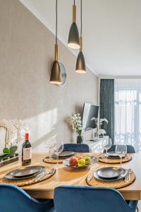 a dining room table with plates and wine glasses at APARTMENT 24H WITH FREE GARAGE AND AC Jagiełły 5 in Wrocław