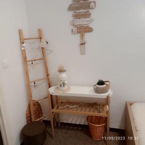 a room with a table and a shelf at La Yeye in Port de la Selva