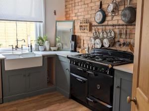 a kitchen with a black stove and a sink at Pass the Keys Spacious Characterful Home in Bournemouth