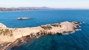 an aerial view of a rocky island in the ocean at Lithos House in Monólithos