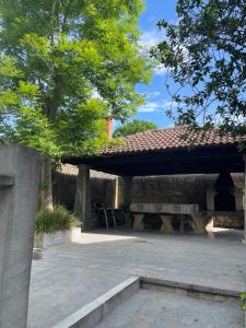 a pavilion with a picnic table in a park at Casa Cardin in Cangas de Onís