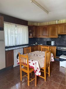a kitchen with a table and chairs and a kitchen with a stove at Casa Cardin in Cangas de Onís