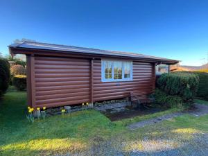 a log cabin with a window on the side of it at Snowdonia Escape in Trawsfynydd