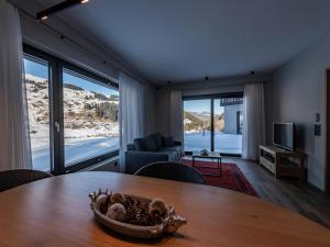 a living room with a table and a couch at Ferienwohnung Tschuppina Schiess in Brigels +2 photos