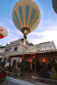 a large hot air balloon flying over a hotel at Underground Cave Suites Hotel in Goreme