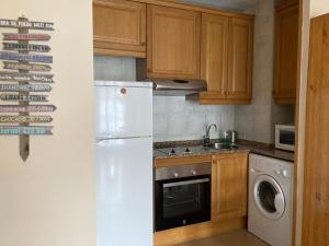 a kitchen with a refrigerator and a washer and dryer at Roxy House - Apartamento a pie de pistas de Espot in Espot