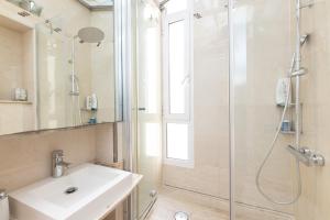 a bathroom with a sink and a shower at ApartEasy - Modernist flat in Eixample center in Barcelona