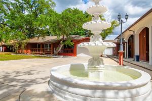 a white fountain in front of a building at Huge Waterfront Mini-Resort with Gym, Dock and Pool in Riverview