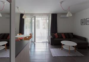 a living room with a couch and a table at Dobó Apartman in Szeged