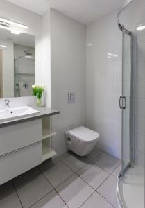 uma casa de banho com um WC, um lavatório e um chuveiro em Dobó Apartman em Szeged