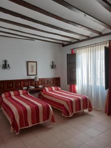 Ένα ή περισσότερα κρεβάτια σε δωμάτιο στο Hotel Nuevo Arlanza