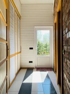 a hallway with a door and a tile floor at VERTIKĀLES in Liepāja