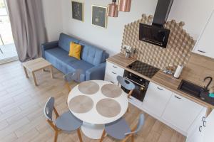 a kitchen and living room with a table and chairs at Apartament obok dworca PKP PKS in Białystok +9 photos