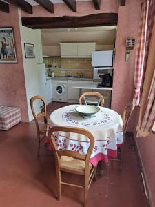 a kitchen with a table with chairs and a table and a table at Domaine de Sainte Anne in Venoy