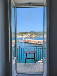 a balcony with a table and a view of the water at Luci del Mari in Ponza