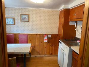 a kitchen with wooden cabinets and a counter top at Amber Lantern Duplex Cottage in Lake George