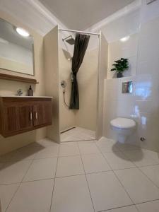 a bathroom with a toilet and a shower and a sink at Apartment Tina, Modern, Private SeaView Outdoor Terrace, BBQ, close to beach, 2 bedrooms in Trogir