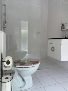 a white bathroom with a toilet and a shower at Apartment Tina, Modern, Private SeaView Outdoor Terrace, BBQ, close to beach, 2 bedrooms in Trogir