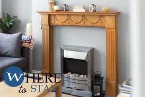 a living room with a fireplace with the words where to stay at Elegant 4bed House-FREE parking in Barrow in Furness
