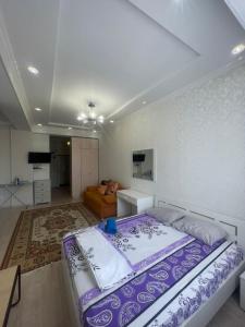 une chambre avec un grand lit et un salon dans l'établissement 1 bedroom Seaside apartments in Green Park 1 комнатная квартира, à Aktau