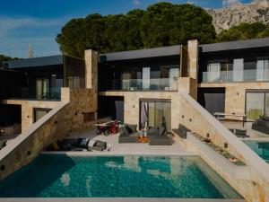 an exterior view of a house with a swimming pool at Villa Kastos in Paleros