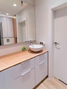 a bathroom with a sink and a mirror at FIRST -- Green Żoliborz Apartment 2 in Warsaw