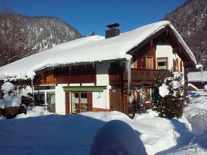 a log cabin with snow on top of it at Haus Schmidberger in Schneizlreuth