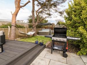 a barbecue grill in the backyard of a house at Valley Pines in Holyhead