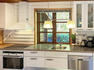 a kitchen with a sink and a window at Peaceful Holiday Home in Jutland with Sauna in Ebeltoft