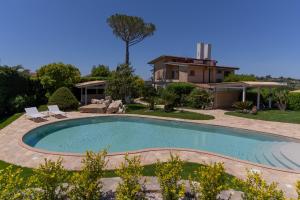 a swimming pool in a yard with a house at Estate4home - Resort Ravenna in Massa Lubrense