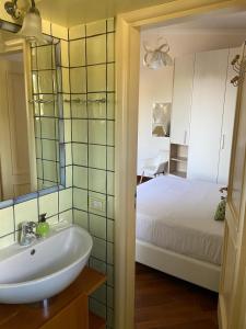 a bathroom with a sink and a bed in a room at Resort Ravenna in Massa Lubrense