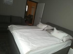 A bed or beds in a room at Talabér Vendégház