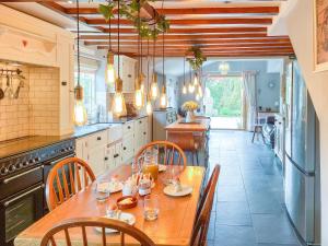 a large kitchen with a wooden table and chairs at Old Church Farm in Hinstock