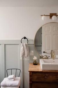 a bathroom with a sink and a mirror at The Dainty Petunia in Picton