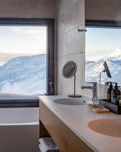 a bathroom with a sink and a large window at Skarsnuten Hotel and Spa by Classic Norway Hotels in Hemsedal