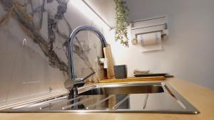 a kitchen sink with a faucet on a counter at Eugenia Levia in Cividale del Friuli +25 photos